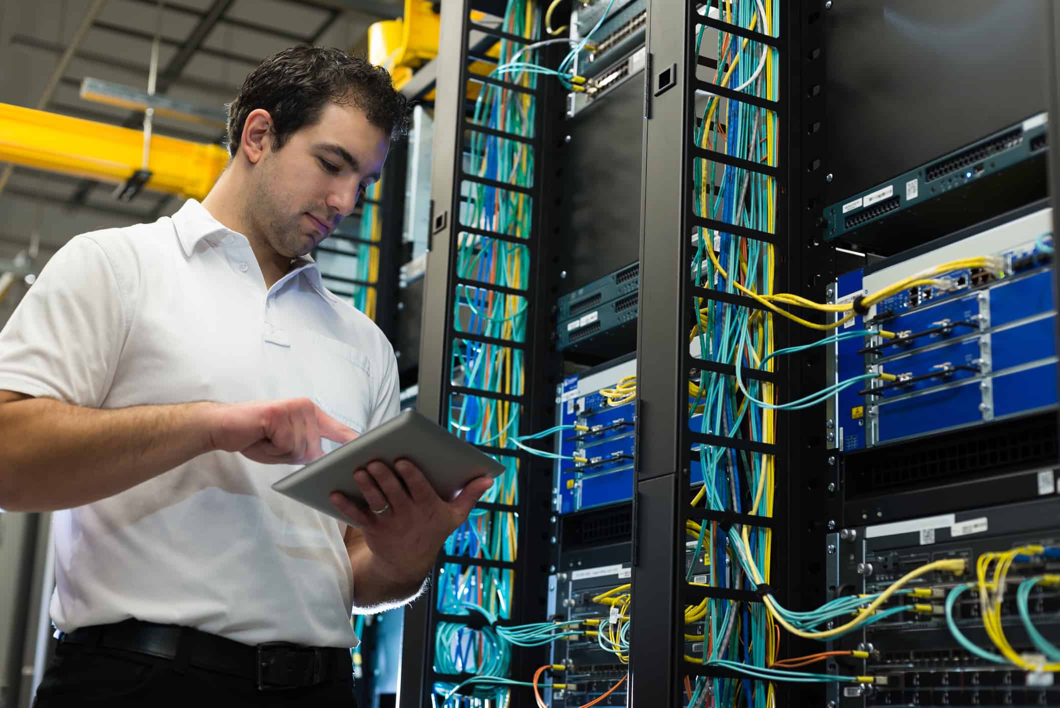 IT technician with network equipment and cables